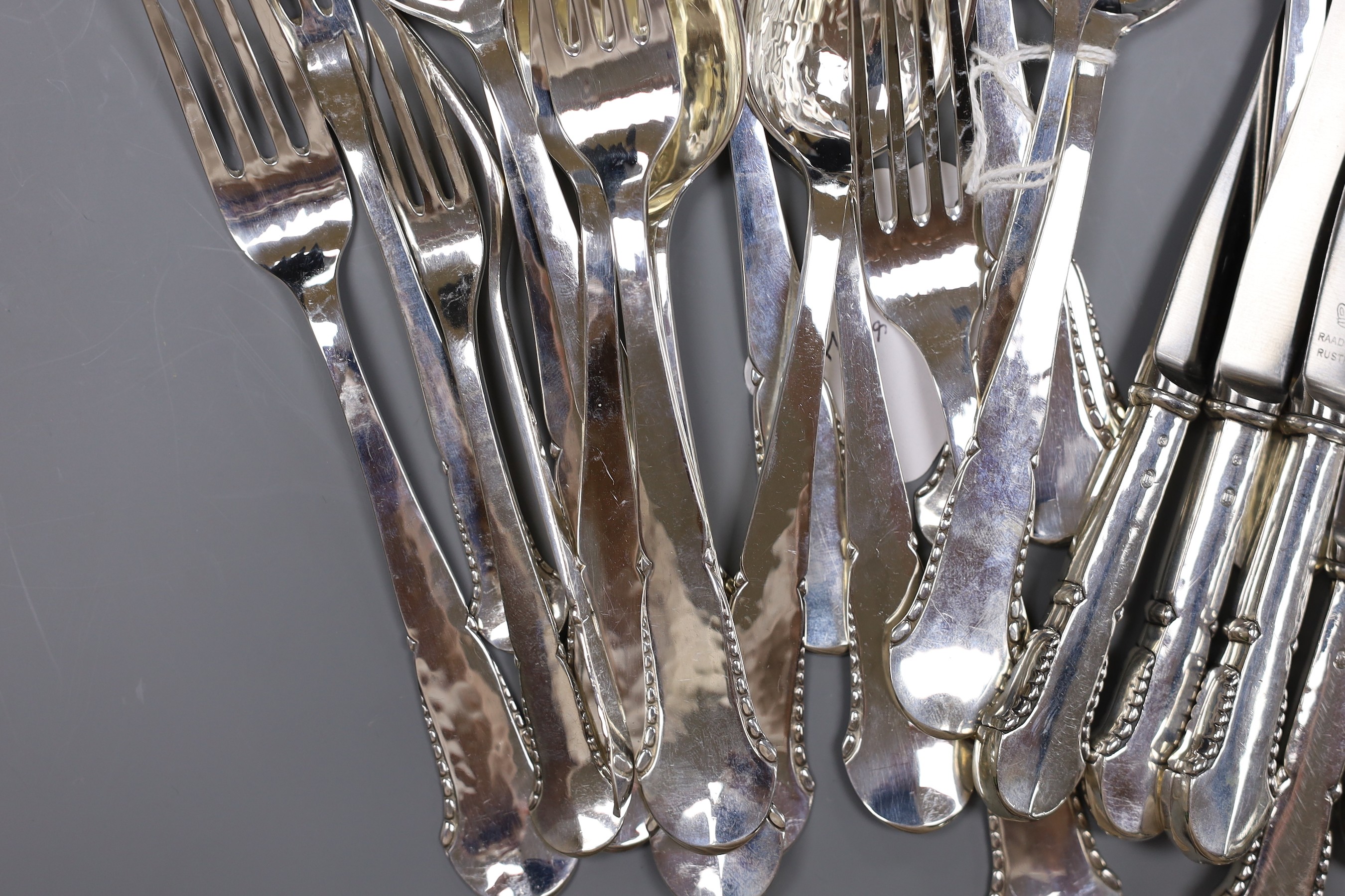 A Danish twenty eight piece white metal canteen of silver flatware and cutlery, comprising ten dessert spoons, six table forks, six three prong forks and six white metal handled steel knives